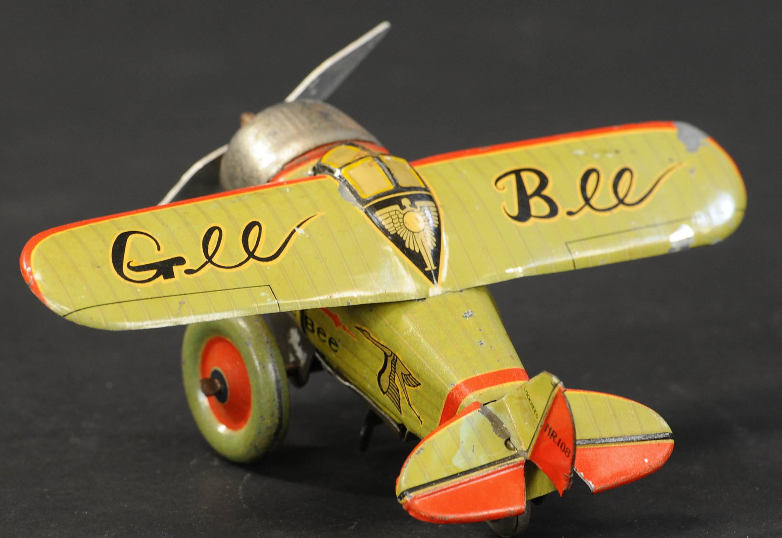 PRE-WAR JAPANESE GEE BEE AIRPLANE: 2071. PRE-WAR JAPANESE GEE BEE AIRPLANE | Japan, E.T. Co, very cute size with nice lithography, wind-up drives propeller and wheels. 7" l. | (Excellent Condition) | $1,000 - $1,400 | Provenance: Sam D