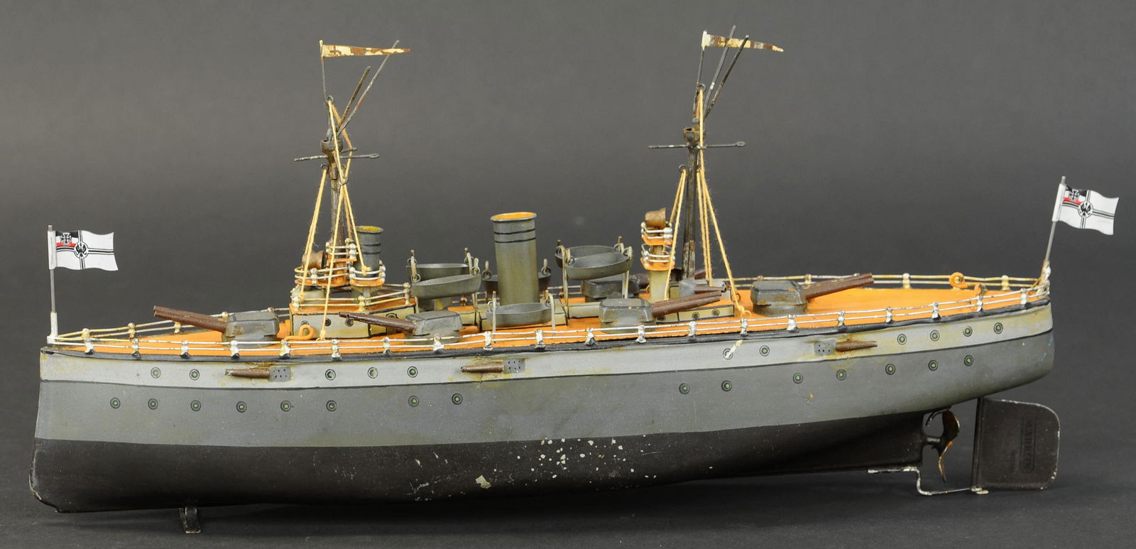 MARKLIN 3RD SERIES BATTLESHIP: 2077. MARKLIN 3RD SERIES BATTLESHIP | Clockwork, accurately scaled ship shows similarly to a model as much as a toy, nice size for displaying. 18" l. | Replaced flags, lifeboats, and funnel, some of t