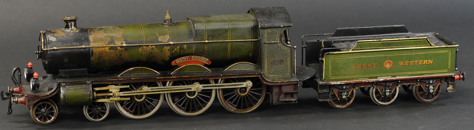 BING FOR BASSETT LOWKE SAINT GEORGE LOCOMOTIVE: 2117. BING FOR BASSETT LOWKE SAINT GEORGE LOCOMOTIVE | Live steam, gauge 2. Loco & tender 27" l. | Headlamps replaced, heavy crazing to all original paint, some flaking at boiler, otherwise (Very Good