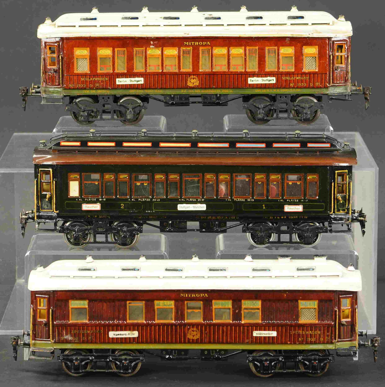 THREE MARKLIN EUROPEAN PASSENGER CARS: 2127. THREE MARKLIN EUROPEAN PASSENGER CARS | Clockwork, gauge 1. 15.5" l. | One white roof has paint chips filled in, green car has paint enhancement to body, overall (Excellent Condition) | $600 - $