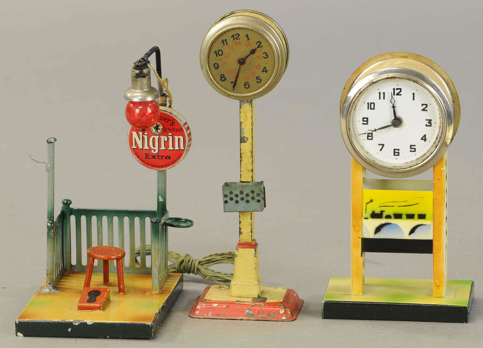 KIBRI SHOE SHINE STAND AND CLOCKS: 2144. KIBRI SHOE SHINE STAND AND CLOCKS | 6" h. | One post on shoe shine is reattached, otherwise in (Excellent Condition) | $300 - $600 | Provenance: Sam Downey Collection.