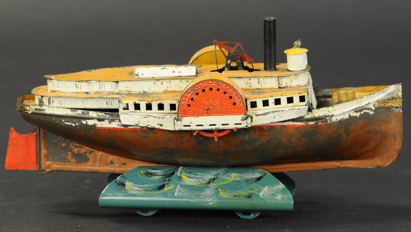 WEEDEN WATER WITCH PADDLE WHEELER: 2175. WEEDEN WATER WITCH PADDLE WHEELER | Live steam, early tin paddle wheel boat 12" l. | Some denting to tin, stack and captain cabin are replacement pieces, overall in (Very Good Condition) | $800 