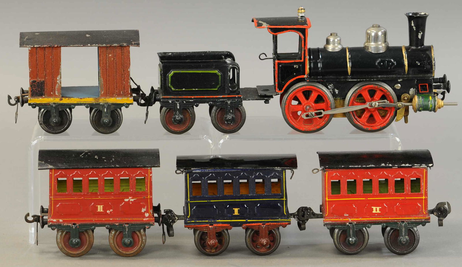 EARLY MARKLIN LOCOMOTIVE & PASSENGER WAGONS: 2251. EARLY MARKLIN LOCOMOTIVE & PASSENGER WAGONS | Loco & tender 12" l. | Reds on locomotive have touch-up, two coaches have repainted roofs, otherwise nice set in (Excellent Condition) | $800 - $1,2