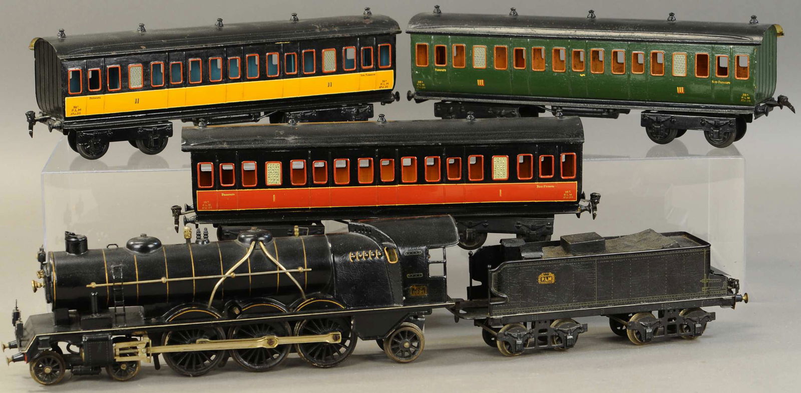 MARKLIN CLOCKWORK PLM PASSENGER SET: 2254. MARKLIN LIVE STEAM PLM PASSENGER SET | Gauge 1, clockwork windcutter locomotive and tender with three class passenger cars. 16.5" l. | Some touch-ups to cars, one roof repainted, loco and tender