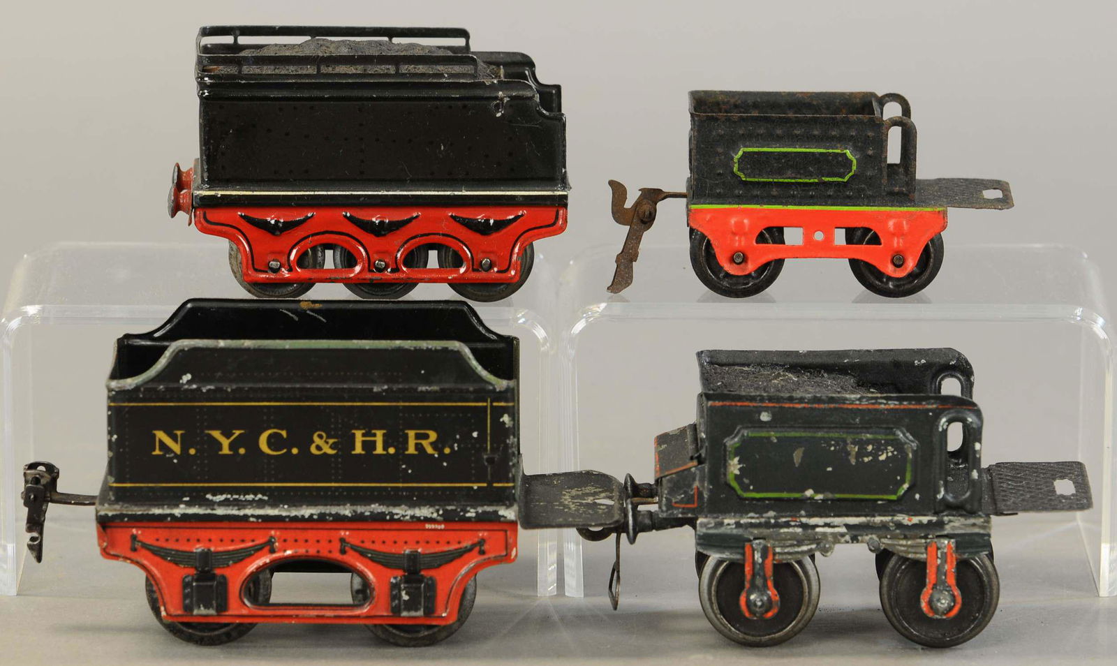FOUR MIXED MARKLIN TENDERS: 2258. FOUR MIXED MARKLIN TENDERS | Two gauge O, two gauge 1, sold as-is parts lot. 6" l. | Green tender has touch-up, others in (Very Good Condition) | $400 - $700 | Provenance: Sam Downey Collection.