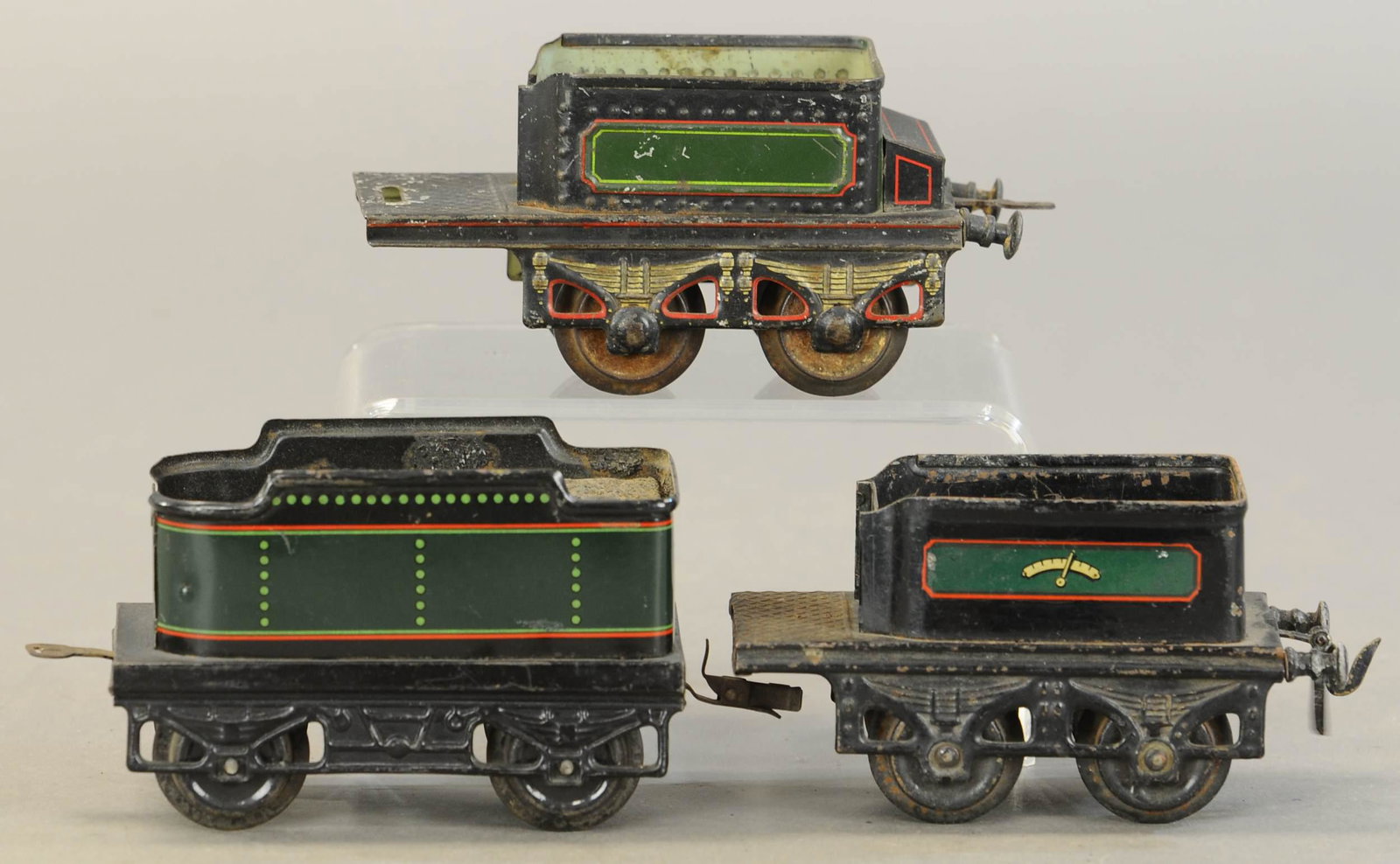 THREE BING AND BUB TENDERS: 2261. THREE BING AND BUB TENDERS | Gauge 1. Longest 5" | One tender has repaint, sold as-is parts lot. | $200 - $400 | Provenance: Sam Downey Collection.