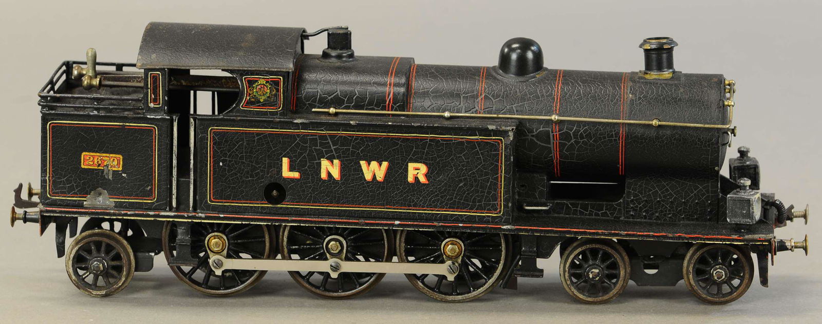 BING FOR BASSETT LOWKE LNWR TANK LOCOMOTIVE: 2287. BING FOR BASSETT LOWKE LNWR TANK LOCOMOTIVE | Clockwork, gauge 2. 17.5" l. | Very minor touch-ups, overall in (Excellent Condition) | $500 - $750 | Provenance: Sam Downey Collection.