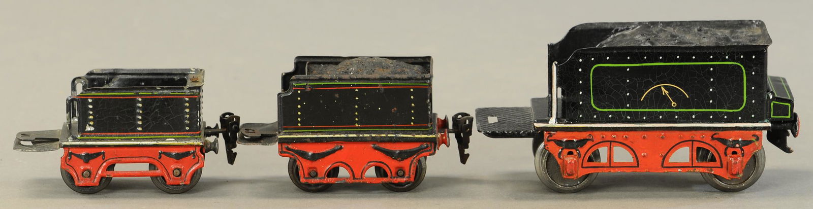 THREE MIXED MARKLIN TENDERS: 2295. THREE MIXED MARKLIN TENDERS | Two gauge O, one gauge 1. 6.5" l. | Large tender is restored, sold as-is parts lot. | $200 - $400 | Provenance: Sam Downey Collection.