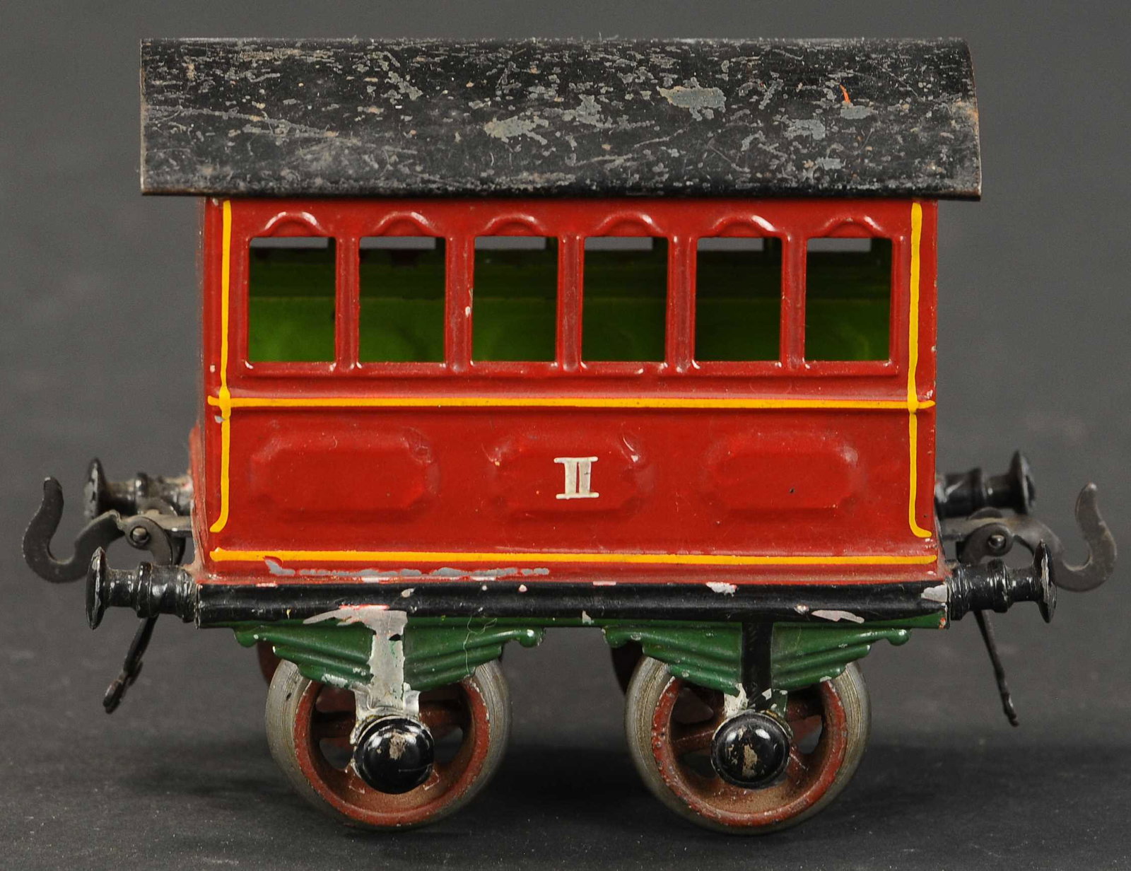 EARLY BING PASSENGER CAR: 2298. EARLY BING PASSENGER CAR | Hand painted, gauge 1. 5.5" l. | Missing two journal covers, otherwise (Very Good to Excellent Condition) | $100 - $200 | Provenance: Sam Downey Collection.
