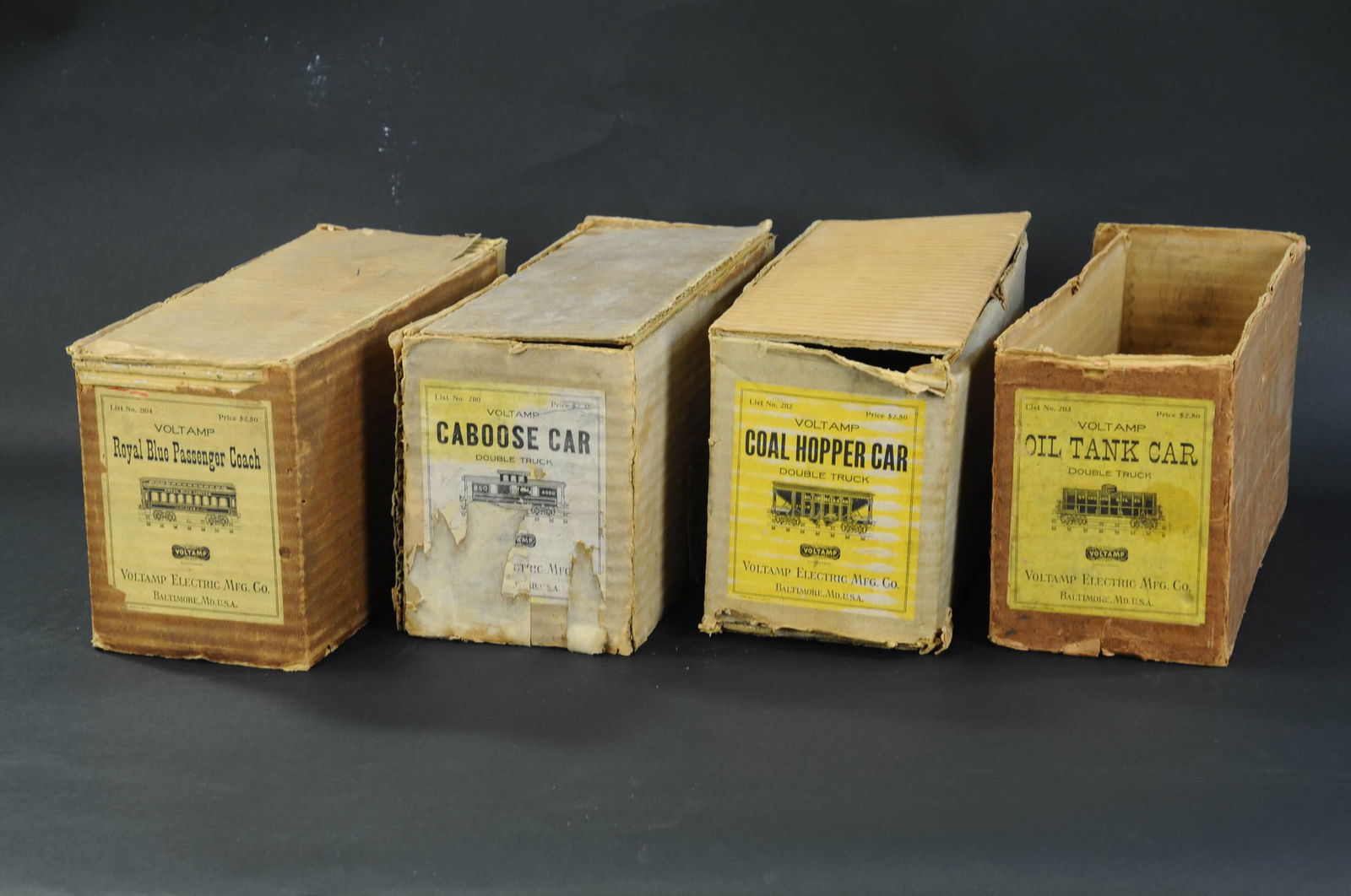 FOUR VOLTAMP FREIGHT CAR BOXES: 2317. FOUR VOLTAMP FREIGHT CAR BOXES | One box missing top and bottom, one box missing top, other two complete, overall (Excellent Condition) for age and rarity. | $400 - $700 | Provenance: Sam Downey