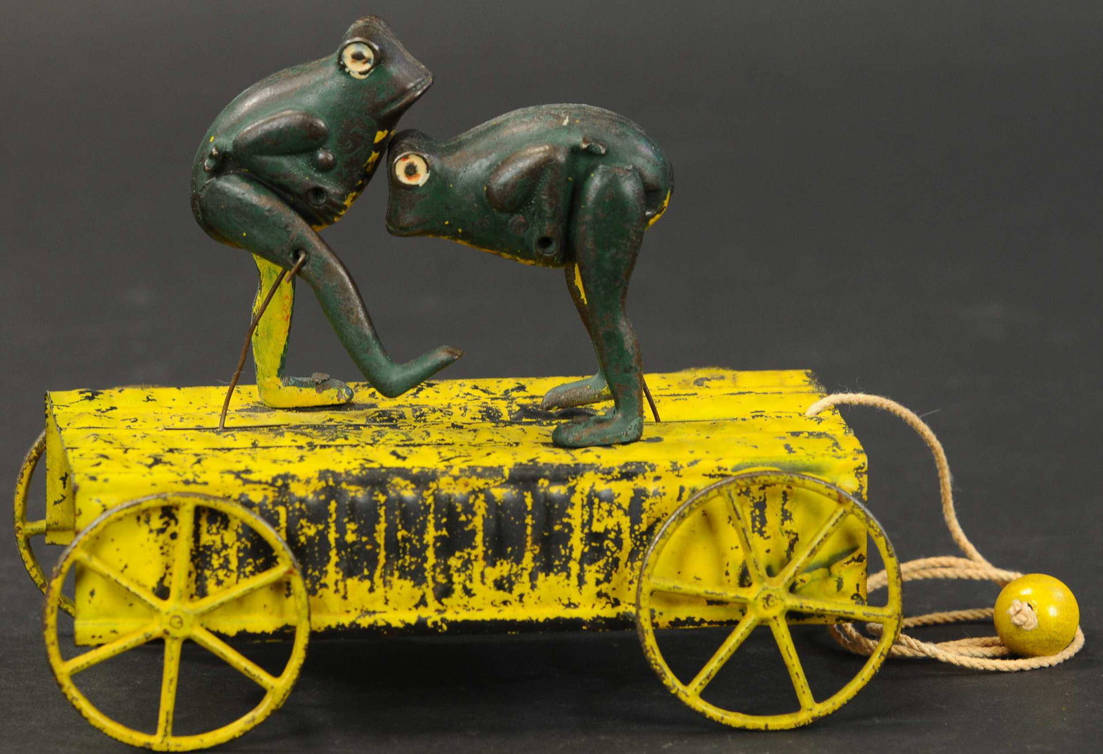 KICKING FROGS PULL TOY: 2363. KICKING FROGS PULL TOY | Sam had a small collection of Frog theme items ranging from tin and cast iron toys to signs and occupational shaving mugs. 7.5" l. | (Very Good Condition) | $400 - $600 