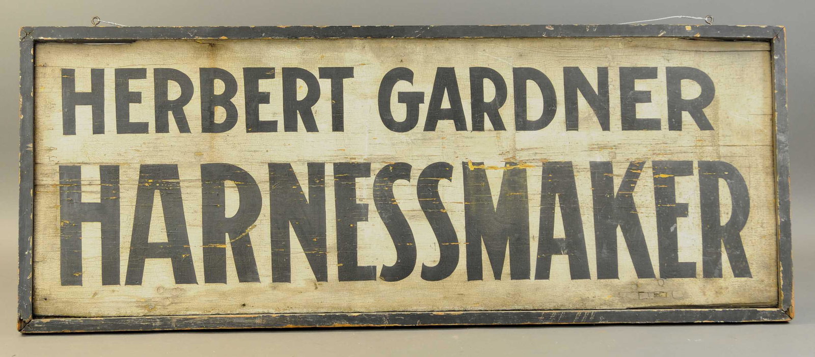 EARLY HARNESS MAKER SIGN: 2405. EARLY HARNESS MAKER SIGN | Two sided wood, framed sign for Herbert Gardner, Harness Maker, show light weathering. 50" x 19" | (VG Cond.) | $250 - $500 | Provenance: Sam Downey Collection.