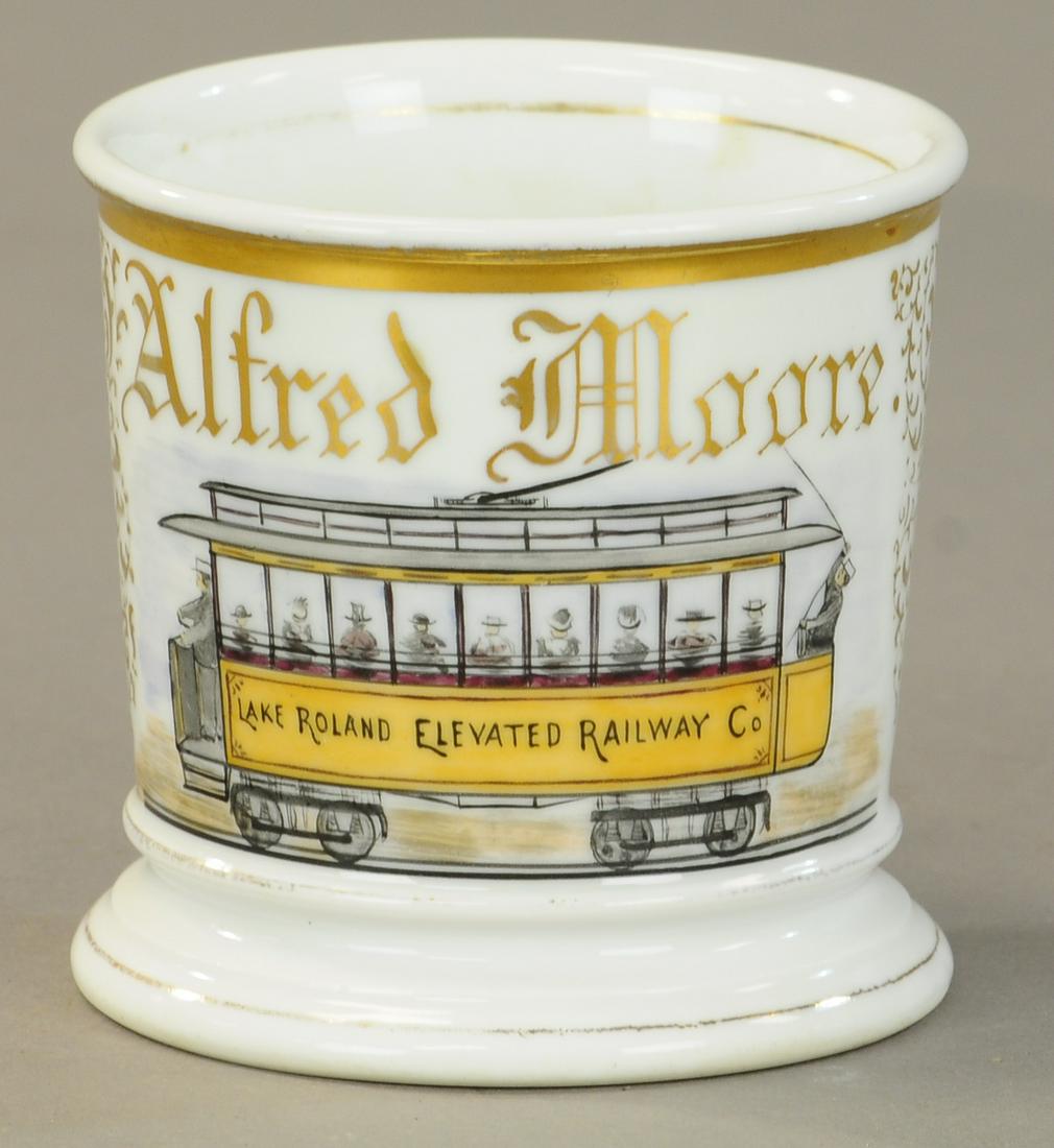 ELEVATED RAIL CAR OCCUPATIONAL SHAVING MUG: 2416. ELEVATED RAIL CAR OCCUPATIONAL SHAVING MUG | Rare Nice view of car with passengers and 2 workers. No damage with 20% gold loss. | As Noted. | $500 - $700 | Provenance: Sam Downey Collection.