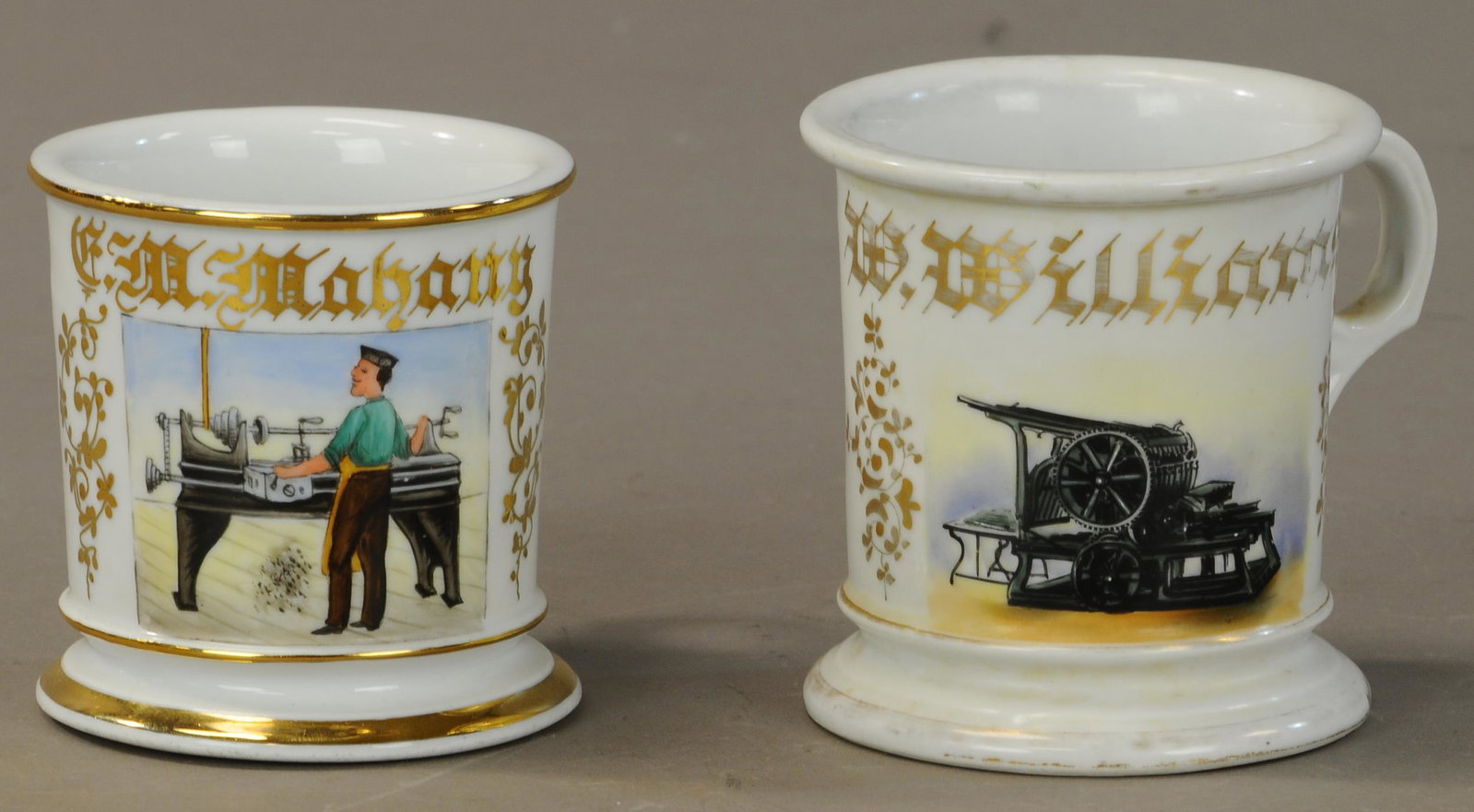 TWO MUGS - PRINTER & LATHE WORKER: 2417. TWO MUGS - PRINTER & LATHE WORKER | Printer - Koken on base—90% gold loss no damage large blank. Lathe Worker - Full gold worker in good color. Has crow’s foot crack on bottom of base. | As 