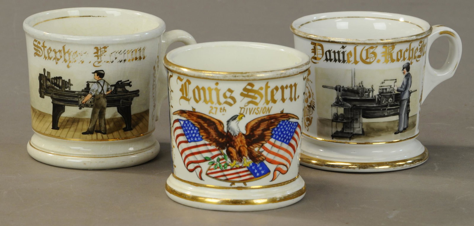 THREE MUGS - LATHE WORKERS & WW1 VETERAN: 2418. THREE MUGS - LATHE WORKERS & WW1 VETERAN | Ww1 Veteran - Eagle and flags and the “27th Division”. Semi-vitreous blank. Gold loss to rims - blue wrap shows wear No damage. Lathe Worker - Semi