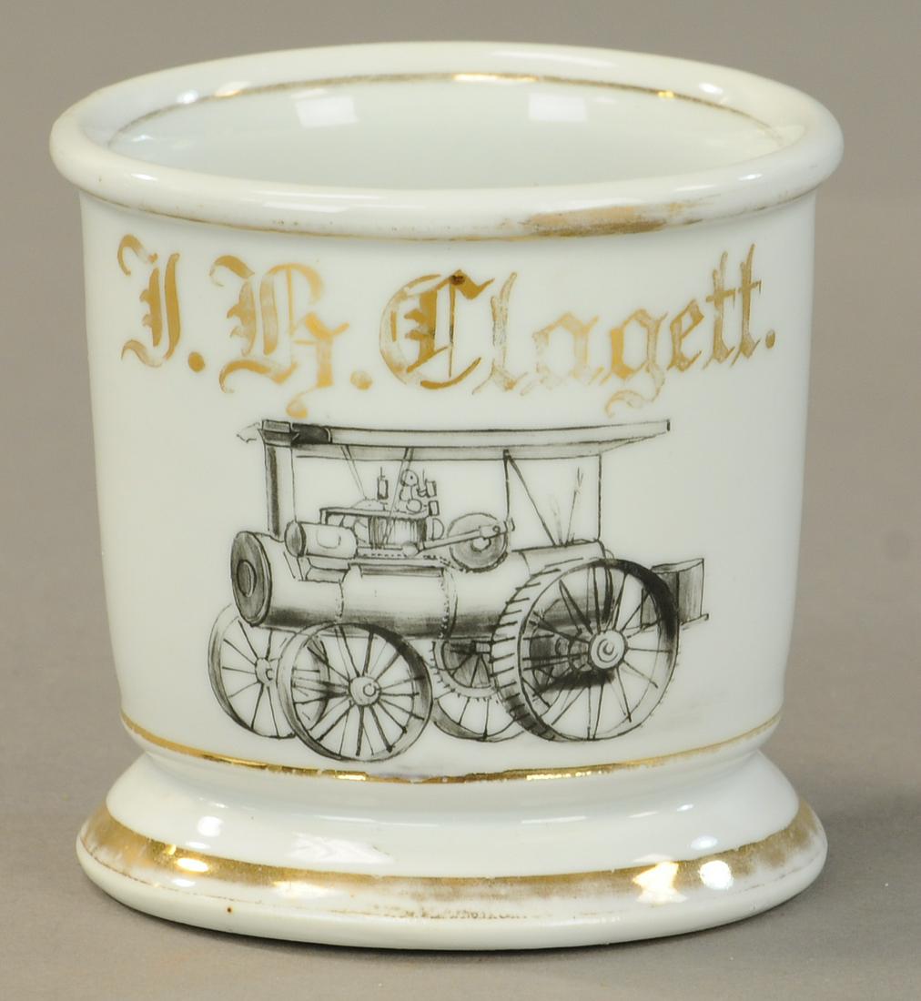 EARLY STEAM TRACTOR OCCUPATIONAL SHAVING MUG: 2422. EARLY STEAM TRACTOR OCCUPATIONAL SHAVING MUG | Black & white illustration no damage 50% gold loss. | As Noted. | $500 - $800 | Provenance: Sam Downey Collection.
