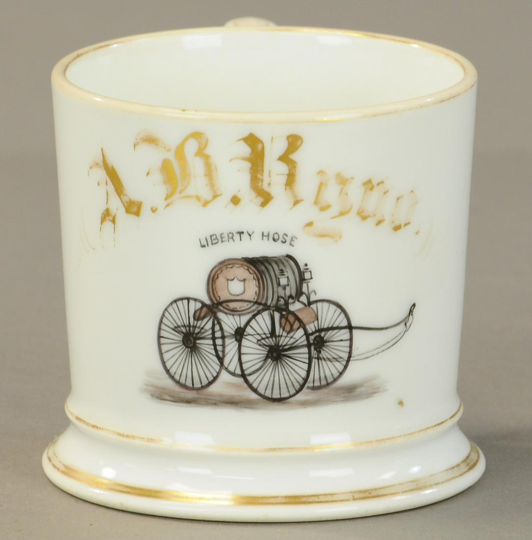LIBERTY FIREMAN HOSE WAGON SHAVING MUG: 2423. LIBERTY FIREMAN HOSE WAGON SHAVING MUG | Has “Liberty Hose” on wagon. Small early blank. No damage 50% gold loss. | As Noted. | $250 - $400 | Provenance: Sam Downey Collection.