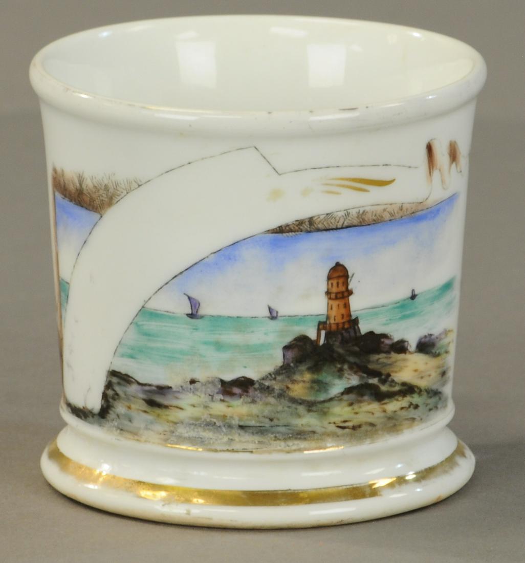 NEW ENGLAND LIGHT HOUSE SHAVING MUG: 2454. NEW ENGLAND LIGHT HOUSE SHAVING MUG | Decorative view of light house and water scene. Berninghaus stamp on base. Name worn off no damage. | As Noted. | $250 - $350 | Provenance: Sam Downey Colle