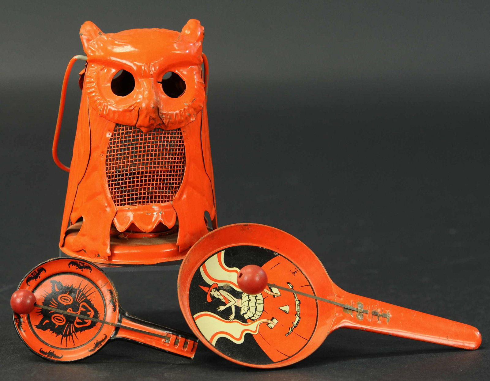 PAINTED TIN OWL LANTERN & TWO NOISE MAKERS: 2484. PAINTED TIN OWL LANTERN & TWO NOISE MAKERS | Owl lantern w/candle holder and two tin pan clangors. Lantern 6", noise maker 5" & 8". | (Excellent Condition) | $100 - $300 | Provenance: Sam Downey