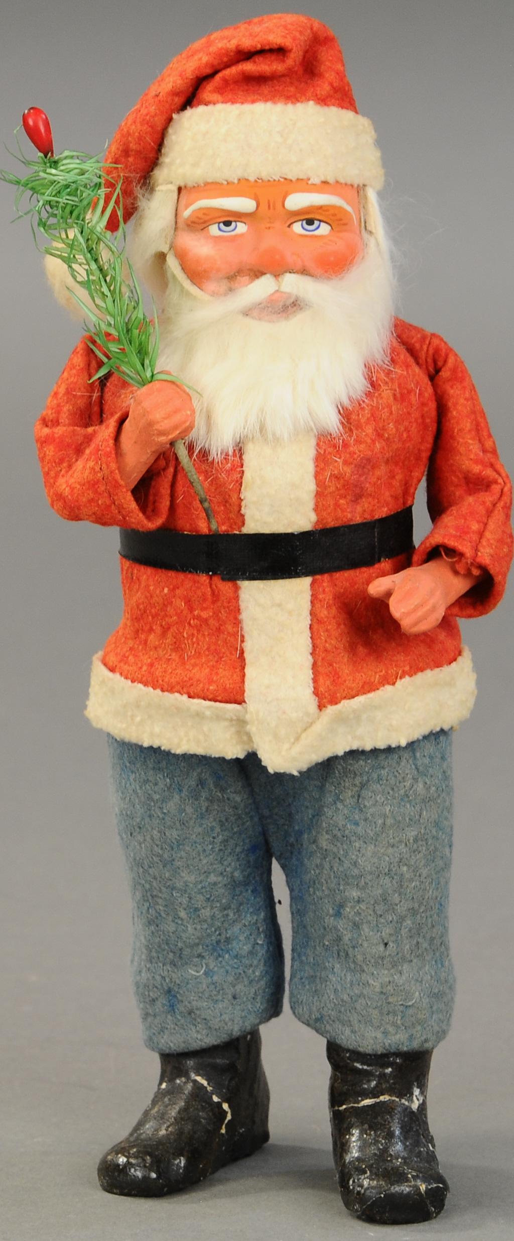 WOODCUTTER SANTA CANDY CONTAINER: 2498. WOODCUTTER SANTA CANDY CONTAINER | Germany, composition Santa, rabbit fur beard and feather tree in hand. 10.5" h. | Broken feet reglued, (Good Cond.) | $200 - $300