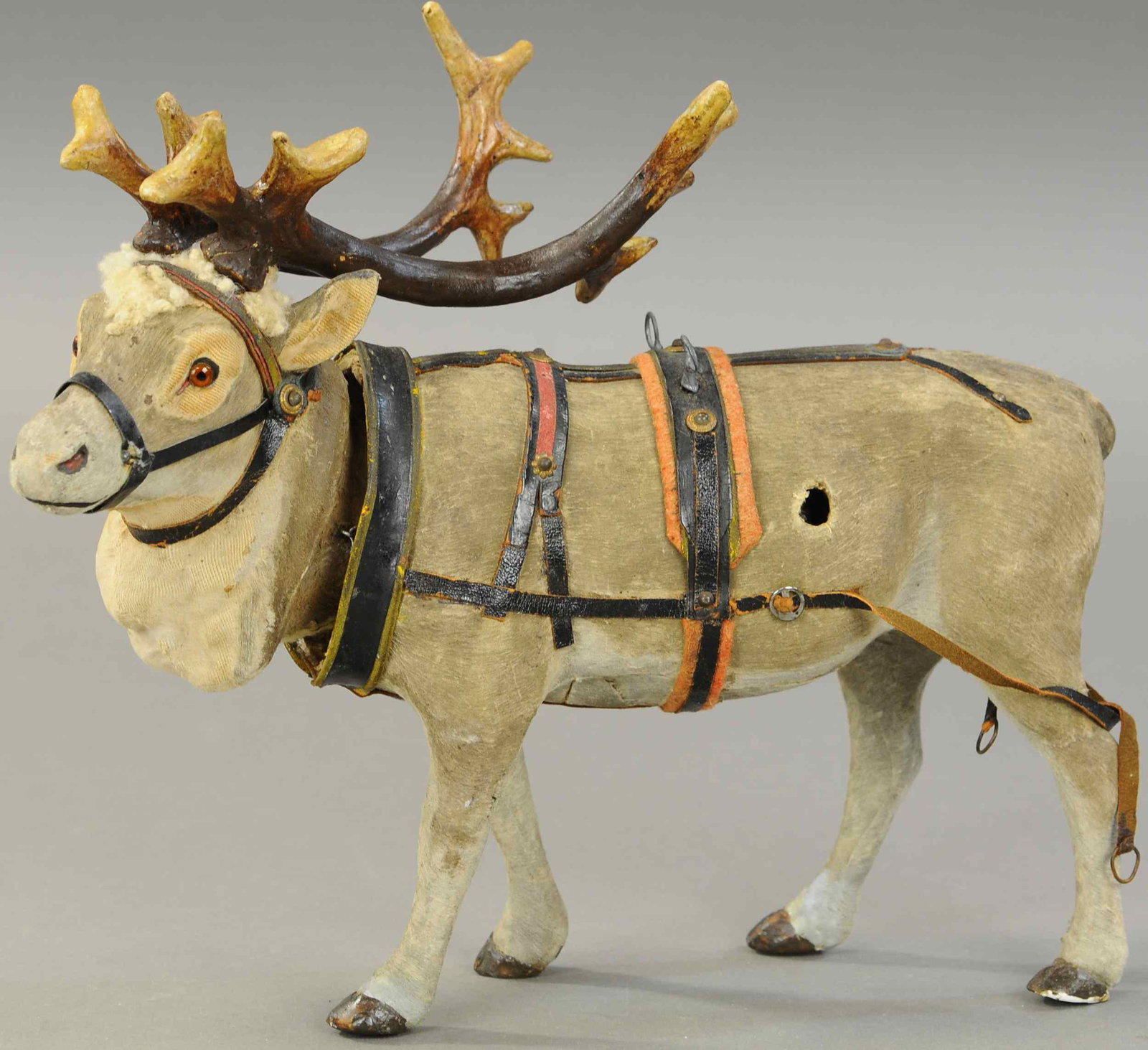 MAGNIFICENT NODDING REINDEER: 2566. MAGNIFICENT NODDING REINDEER | Germany, brown glass eyes, composition antlers, full leather harness & collar, ready to pull Santa's sleigh, a hard to find example in good working order. 12" h. |
