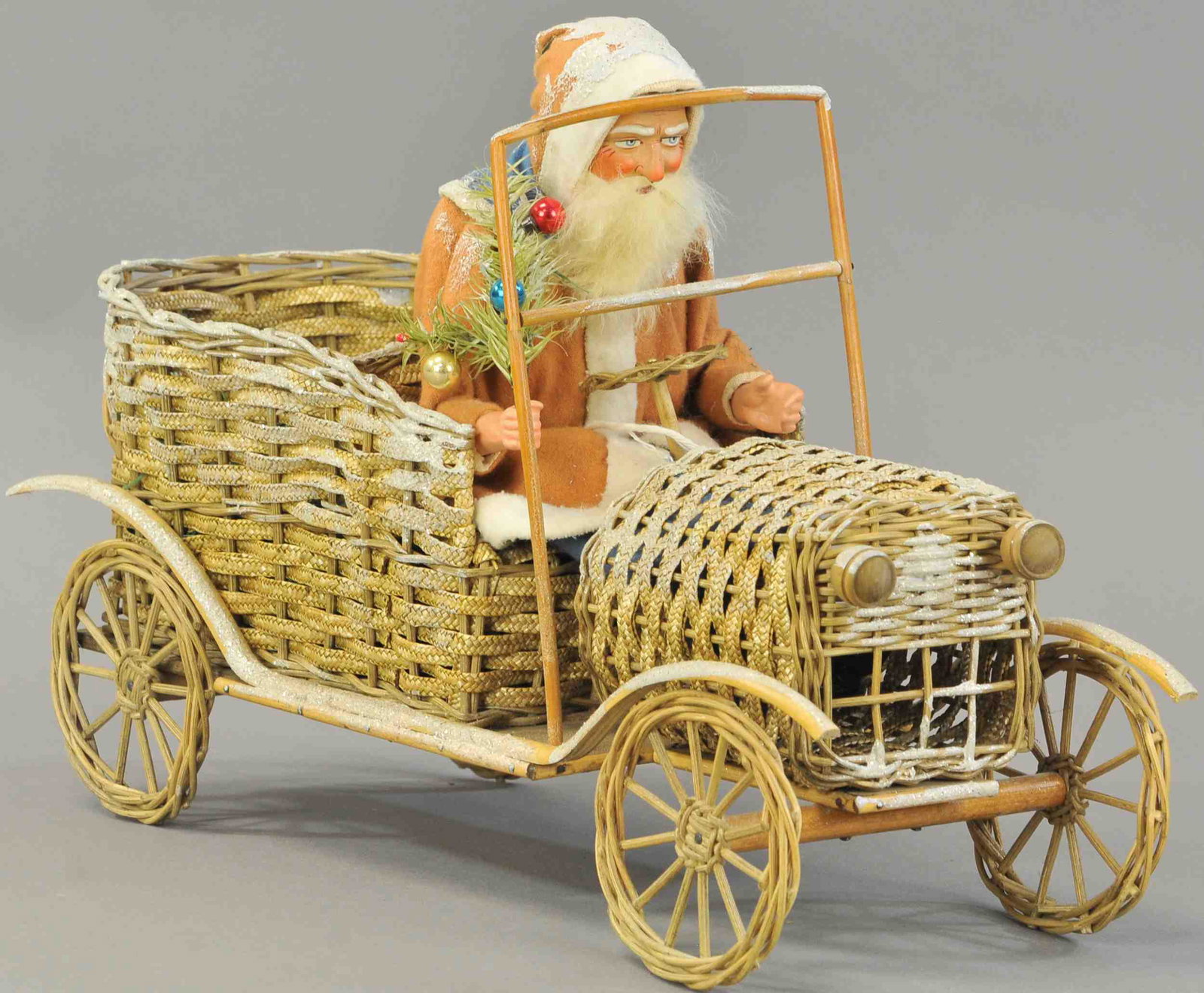 SANTA DRVING HIS FABULOUS MOTOR CAR: 2604. SANTA DRVING HIS FABULOUS MOTOR CAR | A determined looking Santa Claus at the wheel of his marvelous looking, snow flaked auto of woven wicker, Santa has a composition head w/rabbit fur beard an