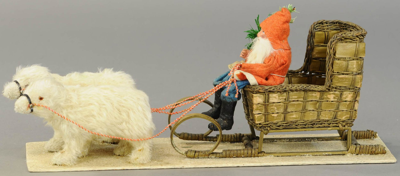 SANTA IN SLEIGH PULLED BY POLAR BEARS: 2606. SANTA IN SLEIGH PULLED BY POLAR BEARS | Composition Santa Claus, red waistcoat & blue trousers, sitting on a woven wicker sleigh, pulled by two wooly polar bears w/brown glass eyes, all mounted 