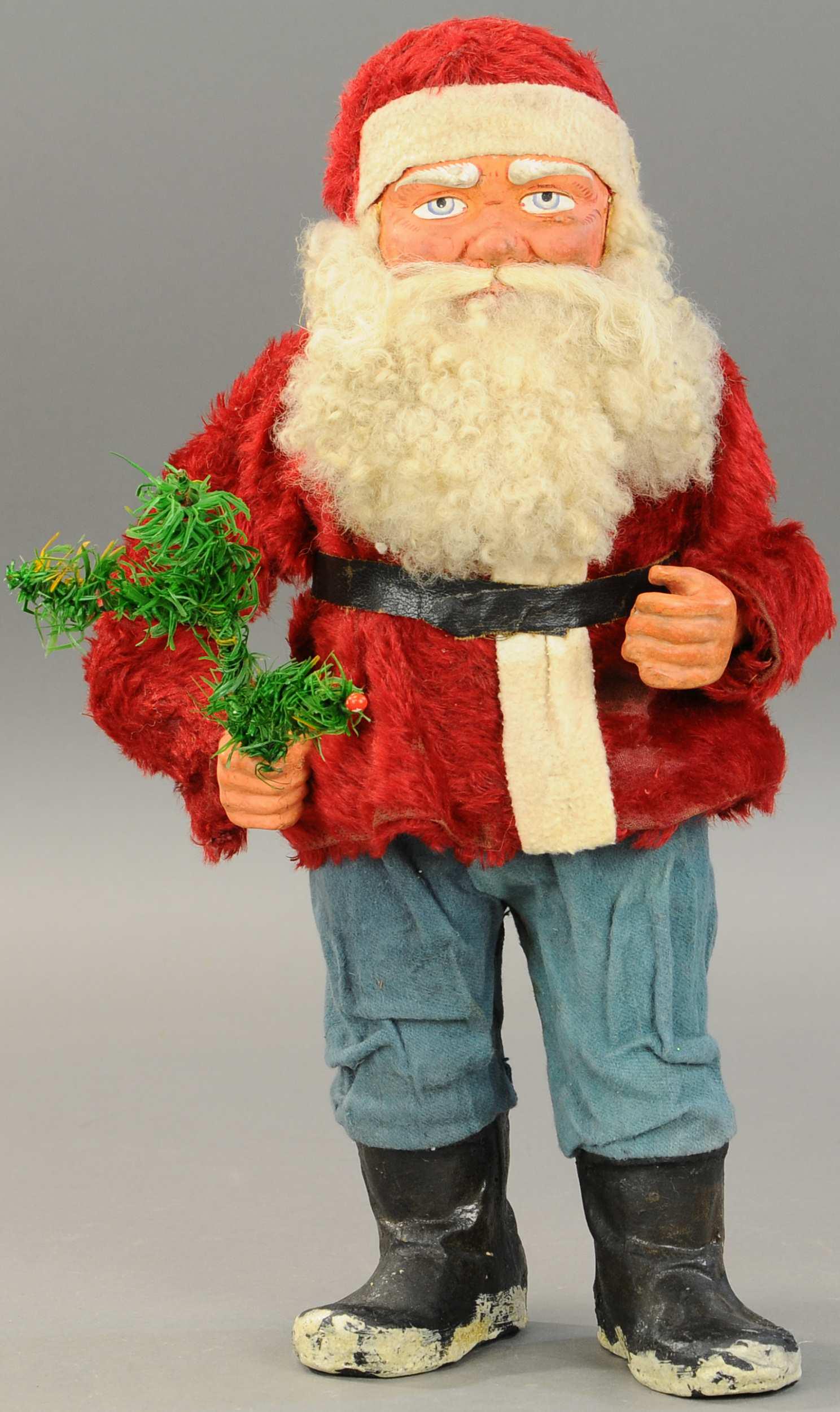 LARGE WOODCUTTER SANTA CANDY CONTAINER: 2609. LARGE WOODCUTTER SANTA CANDY CONTAINER | Germany, composition & cardboard tube body, an impressive size Santa Claus, wearing a furry red waistcoat, his deep blue eyes are looking out over a bush