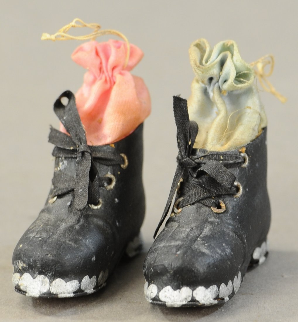 TWO DRESDEN SHOE CANDY CONTAINERS: 2615. TWO DRESDEN SHOE CANDY CONTAINERS | Germany, two realistic looking shoes/boots w/silk bags and traces of snow on the sales. | 2" each. | (VG-Exc. Cond.) | 200 - 400