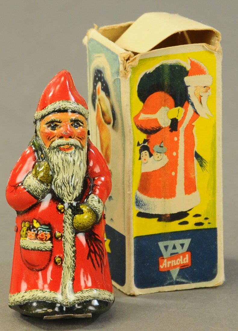 BOXED ARNOLD SANTA CLAUS TOY: 2629. BOXED ARNOLD SANTA CLAUS TOY | A rare find w/box and in pristine condition, key is missing. | 4". | (Exc. Cond.) | 200 - 400