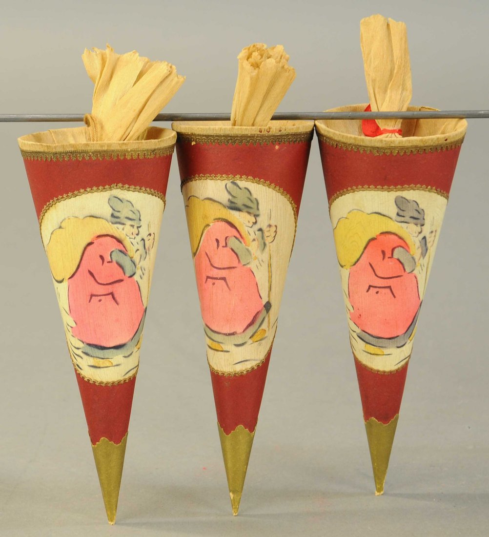 THREE CHRISTMAS CANDY CONTAINERS: 2636. THREE CHRISTMAS CANDY CONTAINERS | Germany, three cone shape, pressed cardboard containers w/Santa Claus, outlined in gold Dresden trim. | 8". | (Exc. Cond.) | 100 - 200