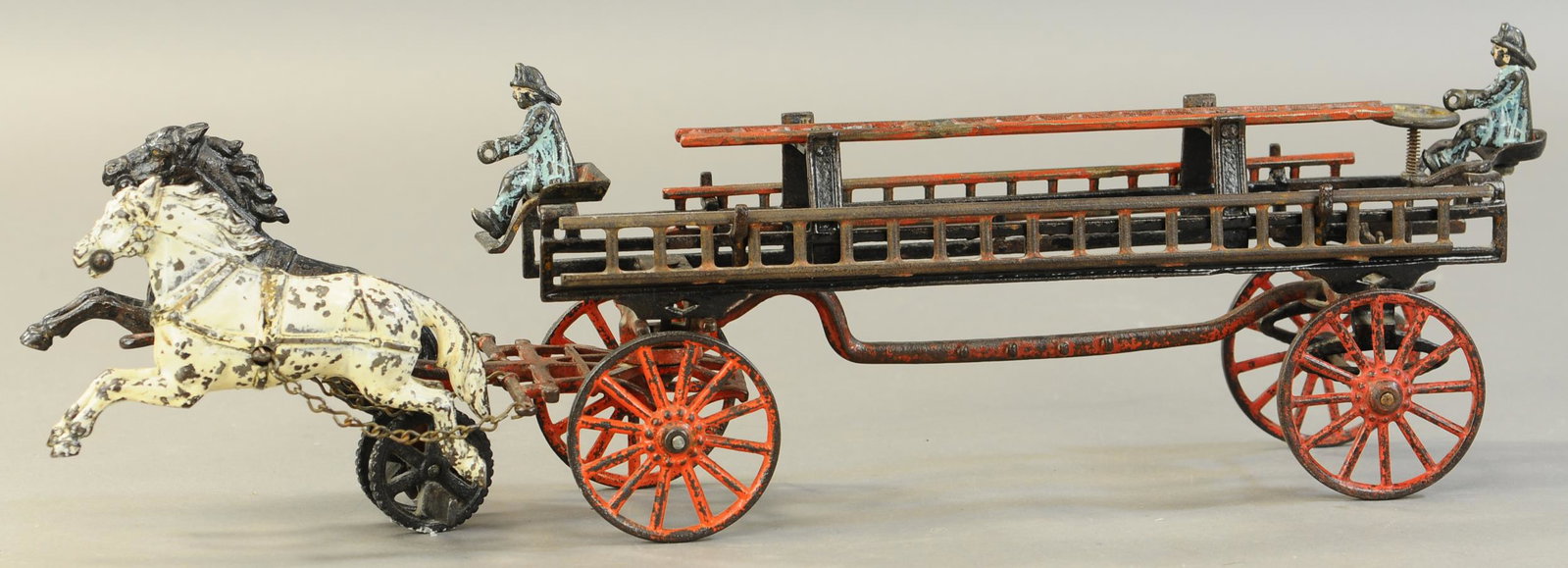 CARPENTER FIRE LADDER WAGON: 90. CARPENTER FIRE LADDER WAGON | 24" l. | One ladder missing, 2 small ladders repaired, chip to post on large ladder, guide wheel on horses is replaced. | $500 - $1,000