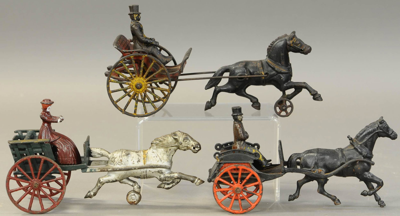 THREE HORSE DRAWN WAGON TOYS: 261. THREE HORSE DRAWN WAGON TOYS| 11" h.| Welker Crosby cart is missing one side post and frame/hitch re-welded to cart.| $200 - $400