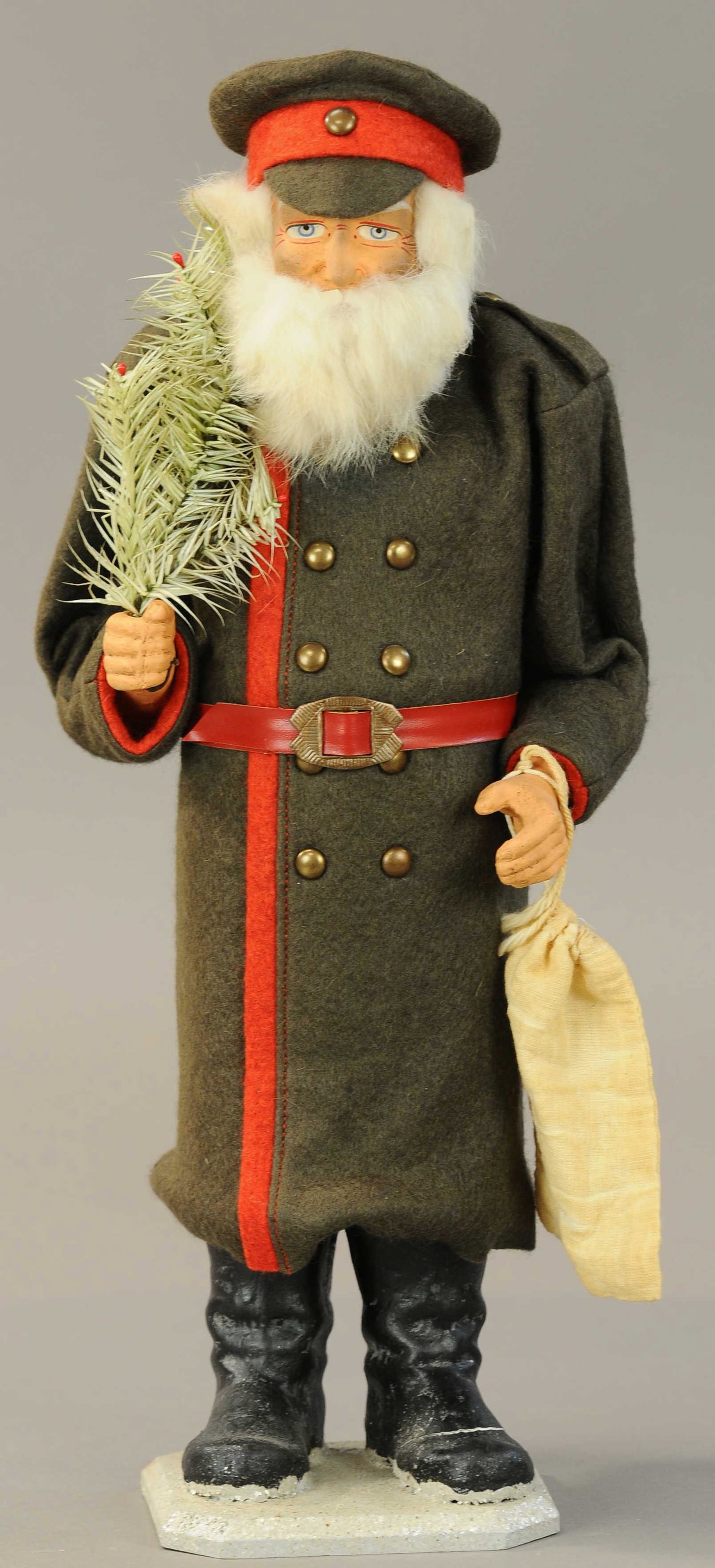 CONTEMPORARY SANTA POLICEMAN CANDY CONTAINER: 281. CONTEMPORARY SANTA POLICEMAN CANDY CONTAINER| Wearing a long brown robe, this figure has a composition face w/rabbit fur beard and is holding a feather tree and toy sack.| 17"| (Exc. Cond.)| $250