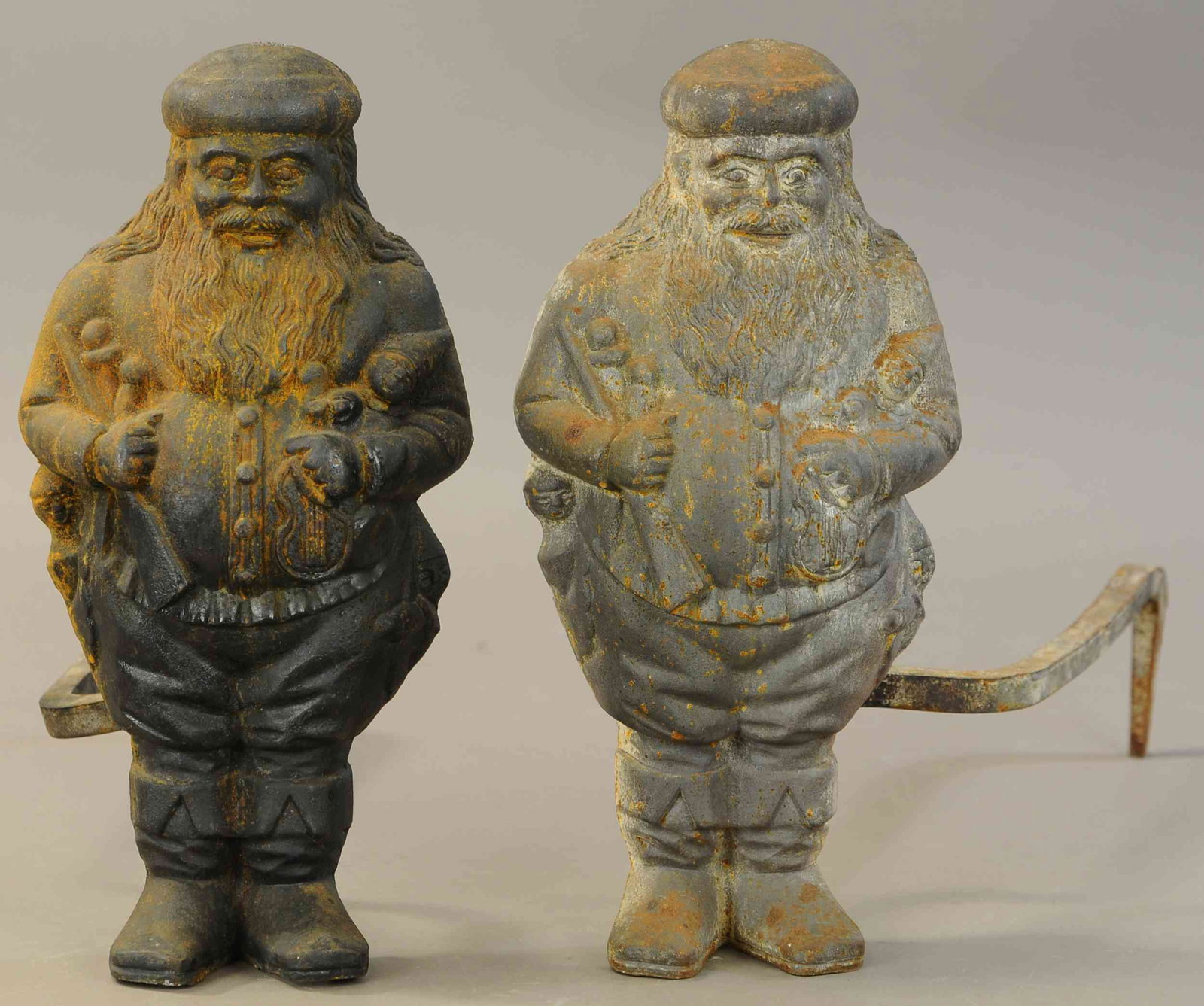 PAIR OF SANTA CLAUS ANDIRONS: 297. PAIR OF SANTA CLAUS ANDIRONS| Great detail throughout, would look fantastic w/fresh coat of paint.| Each 15"| No paint, (Good-VG Cond.)| $250 - $500