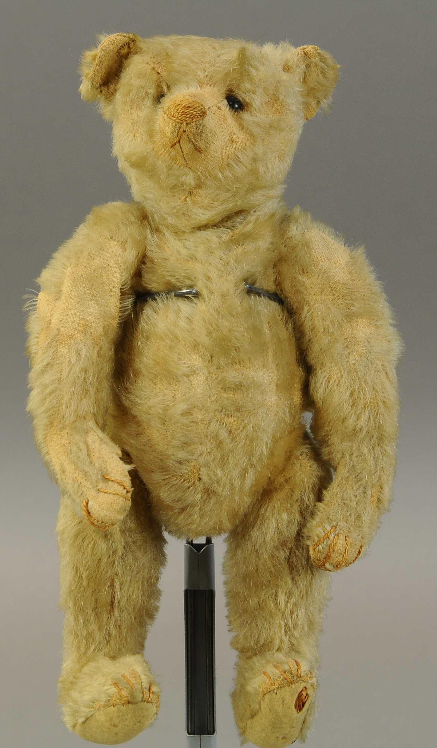 EARLY WELL LOVEY TEDDY: 327. EARLY WELL LOVEY TEDDY| Mokkin bear in Steiff manor with brown stitched nose, mouth and claws, mohair very sparse, shoe button eyes, no button,.| 12"| Claw pads worn with that on right "hand" now