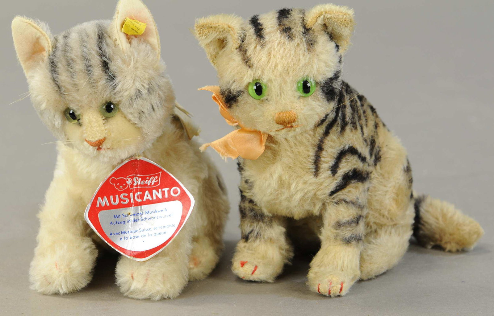 TWO STEIFF CATS: 335. TWO STEIFF CATS| One with wind-up musical tail, one sitting with jointed head, c. 1950.| 8"| (Near Mint Cond.)| $300 - $600