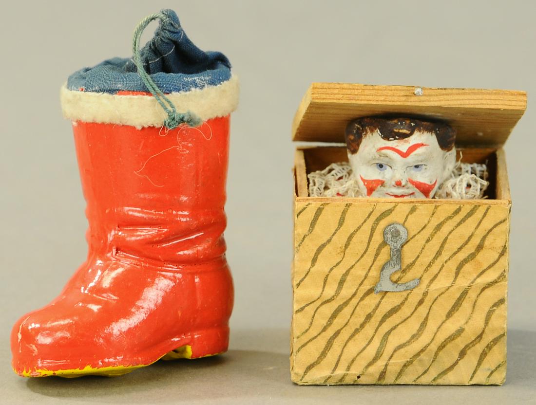 TWO CHRISTMAS CANDY CONTAINERS & JACK-IN-THE-BOX: 359. TWO CHRISTMAN CANDY CONTAINERS & JACK-IN-THE-BOX| Composition head Santa on patriotic cone and boot with blue bag candy containers, along with a Jack-in-the-box made in Germany.| 2.25" - 11"| (VG