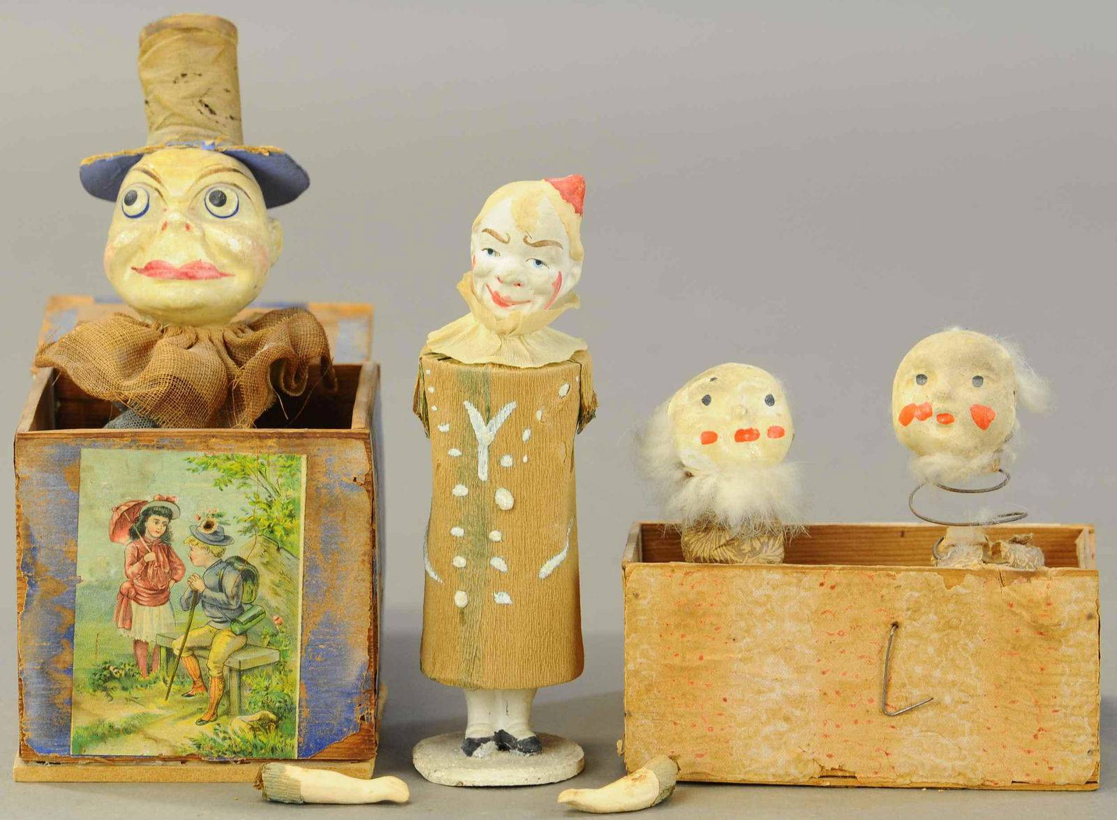 TWO JACK-IN-THE-BOX & CLOWN CHIME TOY: 369. TWO JACK-IN-THE-BOX & CLOWN CHIME TOY| One Jack-in-the-box has a Brownie head with wooden box w/picture, other two has lots of age appropriate wear.| 6" - 7"| Box needs attention, (Fair-Good Cond