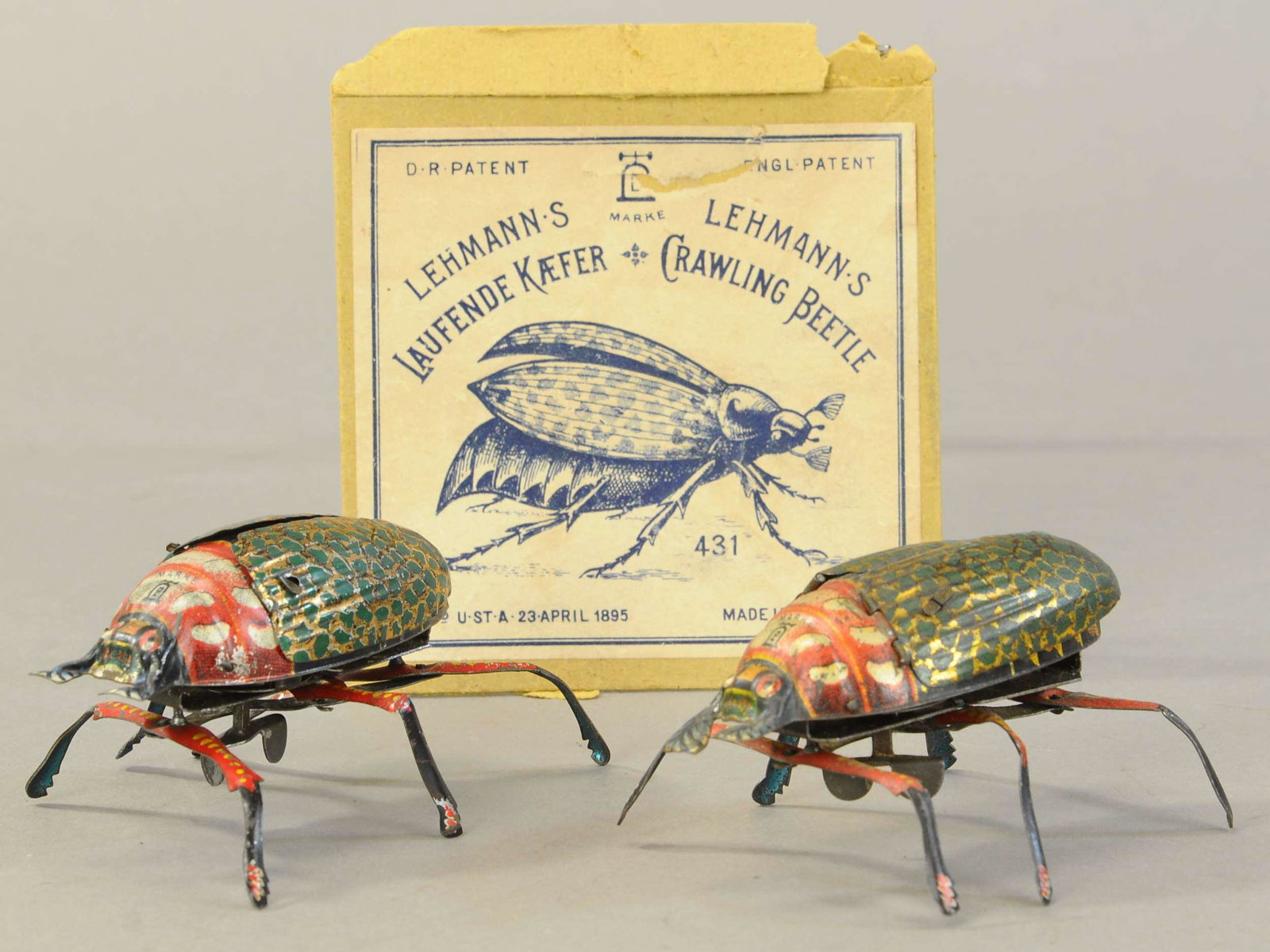 TWO LEHMANN CRAWLING BEETLES / LID: 38. TWO LEHMANN CRAWLING BEETLES / LID | 4" l. | Includes box lid only, toys working in All Original Condition. | $150 - $300