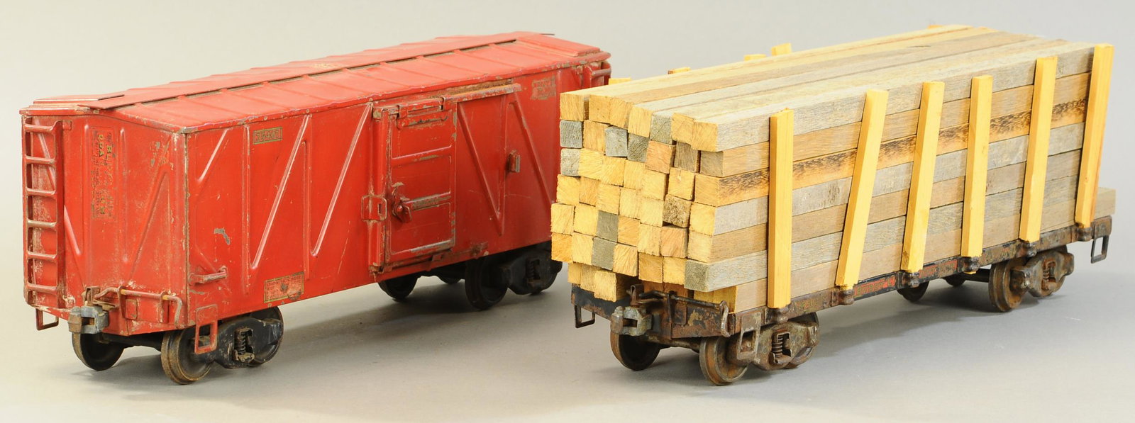 TWO BUDDY L OUTDOOR RR CARS: 311. TWO BUDDY L OUTDOOR RR CARS | 21" l. | Partial couplers, paint in All Original Condition. | $250 - $500