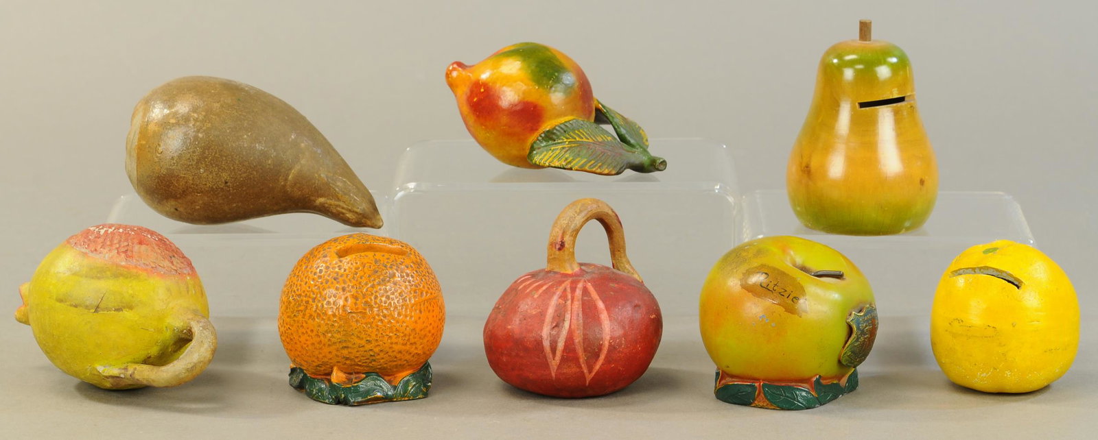 FRUIT THEMED STILL BANK GROUPING: 16. FRUIT THEMED STILL BANK GROUPING | Includes pottery, two pot metal and one wood bank. | Max 5" l. | All Original Condition. | $150 - $300