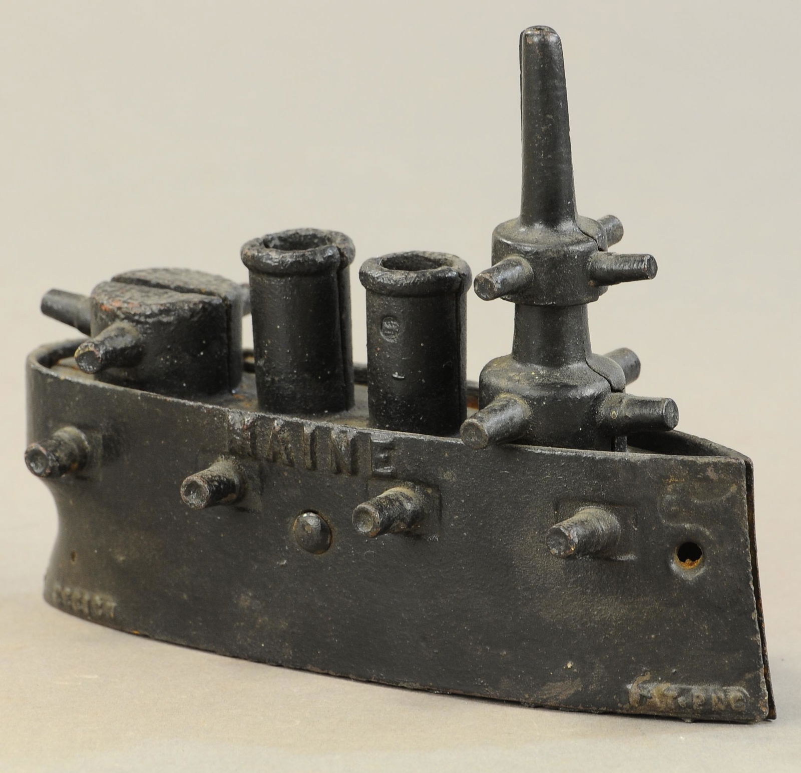 LARGE BATTLESHIP MAINE STILL BANK: 68. LARGE BATTLESHIP MAINE STILL BANK | 7" l. | Missing trap, chipped piece of deck near mast, repainted. | $150 - $300