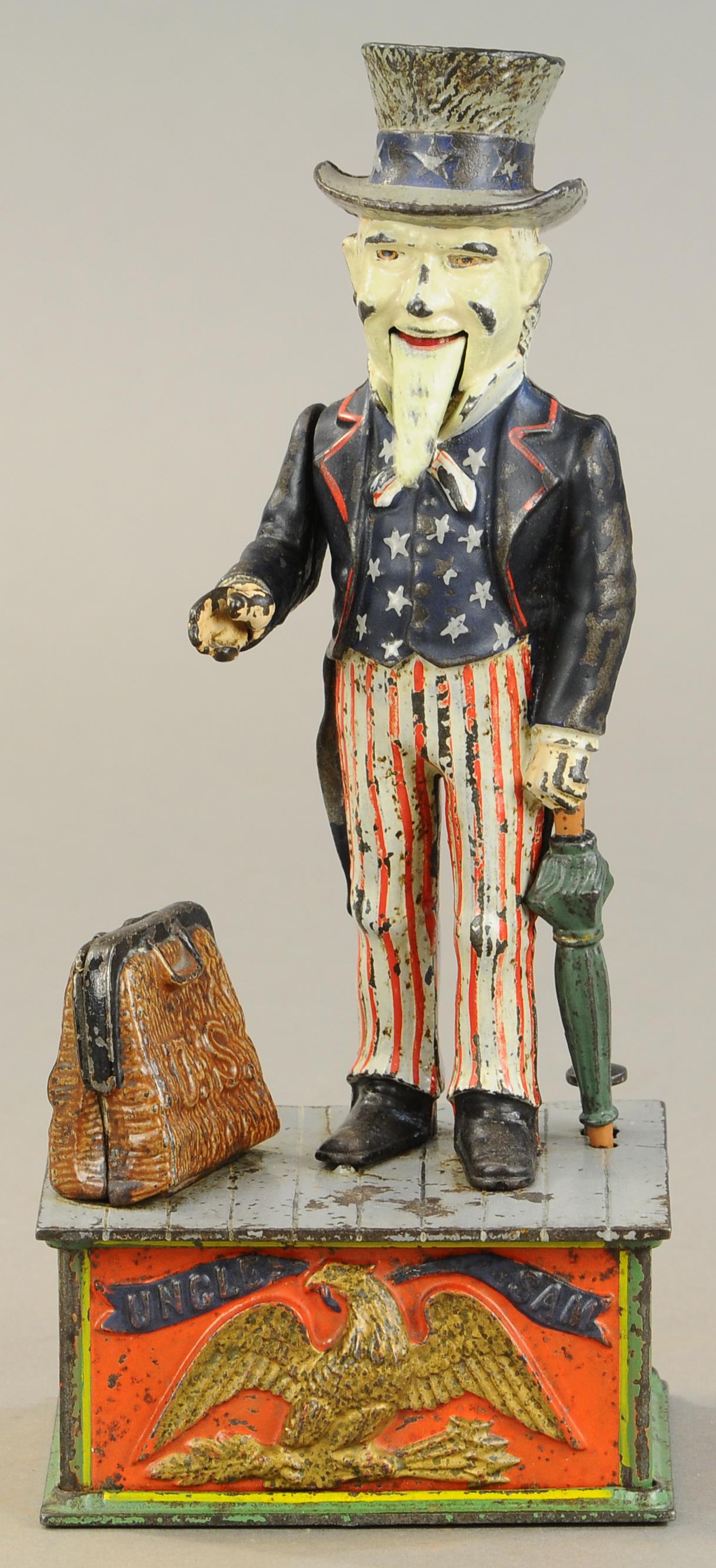 UNCLE SAM MECHANICAL BANK: 116. UNCLE SAM MECHANICAL BANK | Crack at rear of stage from over tightening screw, face and beard have repaint, otherwise paint in All Original Condition. | $500 - $1,000