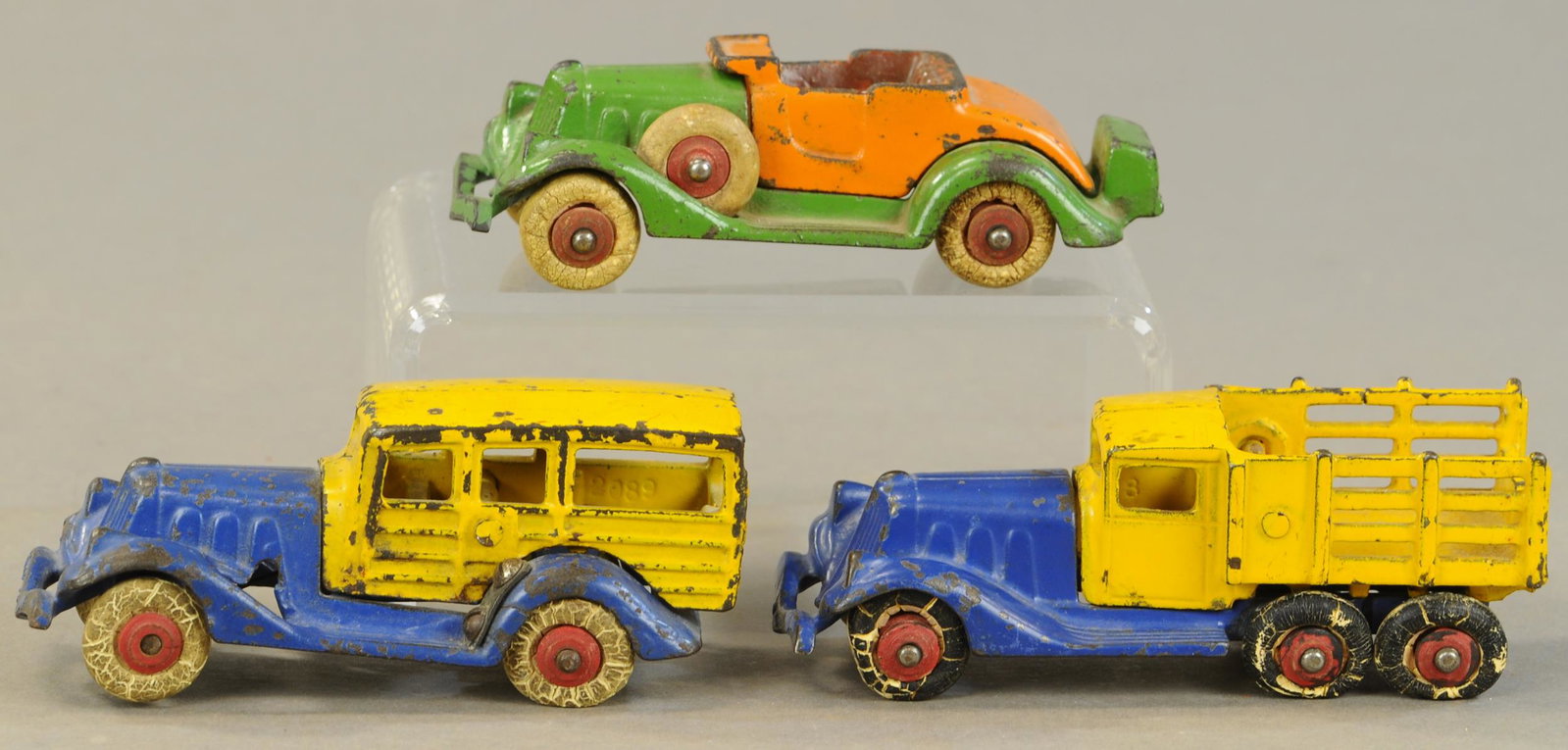 THREE HUBLEY TAKE-APART AUTOS: 348. THREE HUBLEY TAKE-APART AUTOS | 5" l. | Station wagon is missing side fender spare tires, stake truck missing one wheel, paint in All Original Condition. | $150 - $300