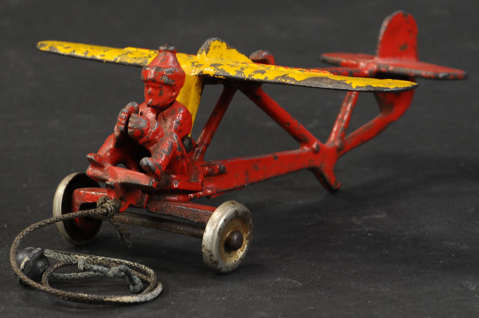 HUBLEY LINDY GLIDER PLANE: 52. HUBLEY LINDY GLIDER PLANE | Scarce smaller size version of two produced by the Pennsylvania company. 6" wingspan. | Small crack behind pilot figure, otherwise in (Very Good Condition) | $600 - $90