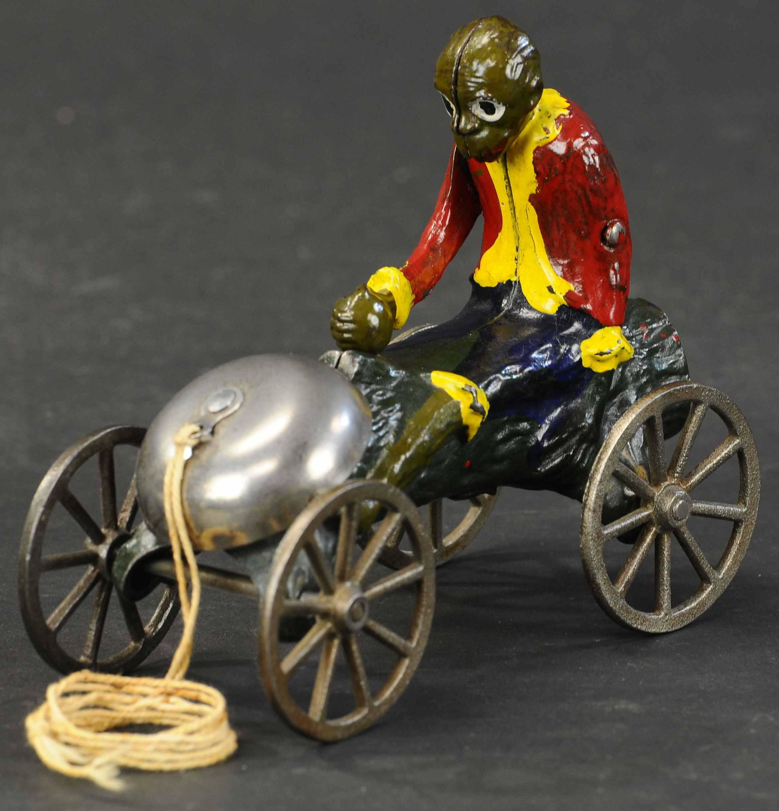 MONKEY W/ COCONUT BELL TOY: 130. MONKEY W/ COCONUT BELL TOY | Kyser & Rex, when toy is pulled, monkey's right arm goes up trying to smash and open the coconut and resulting in bell ringing. 6" l. | (Excellent to Pristine Conditi