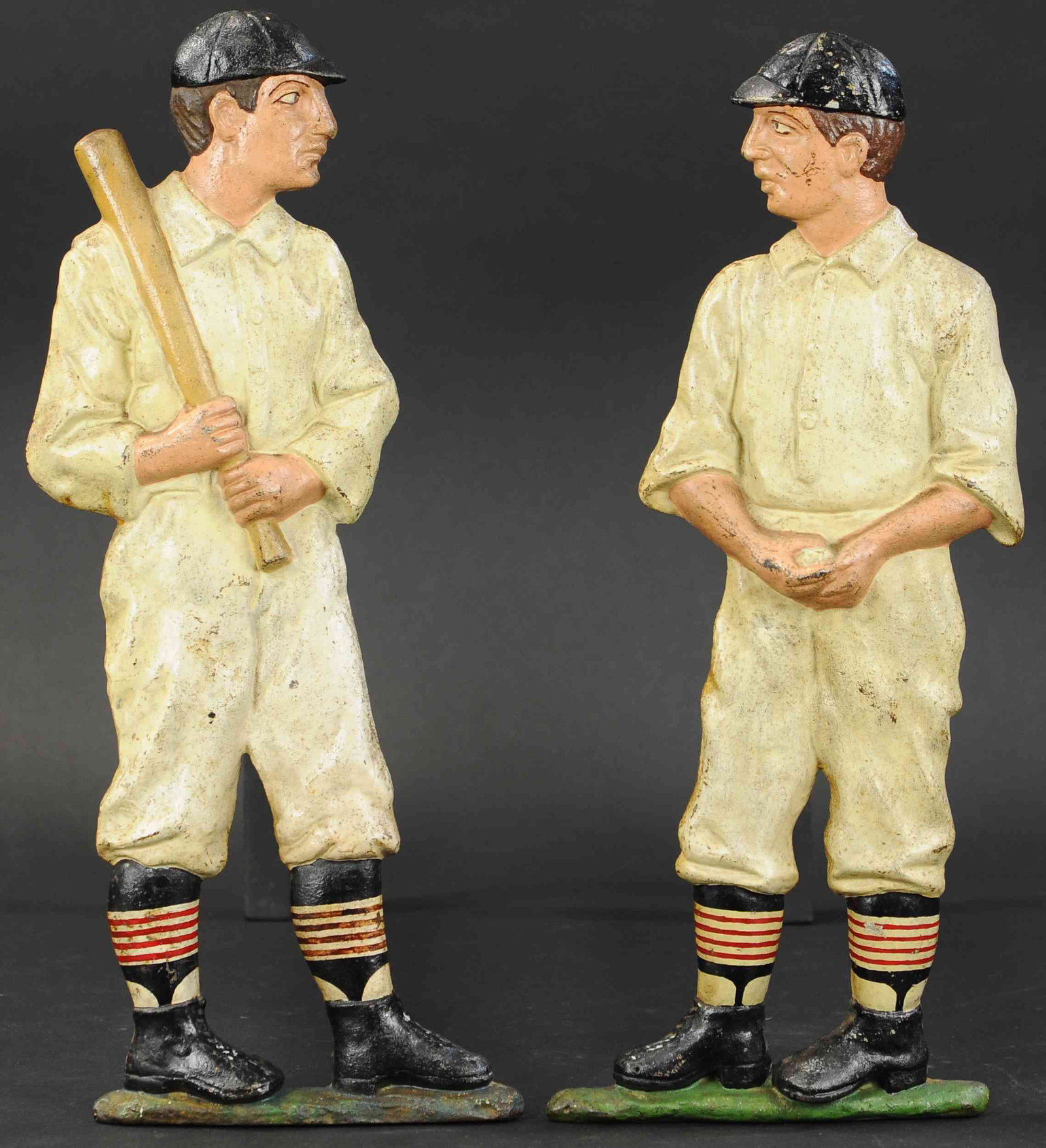 CONTEMPORARY BASEBALL PLAYER ANDIRONS: 187. CONTEMPORARY BASEBALL PLAYER ANDIRONS | Depicting a pitcher and a batter in baseball uniforms and caps, great decorative sporting fireplace accessory complete. 19.5" h. | (Excellent Condition) | 