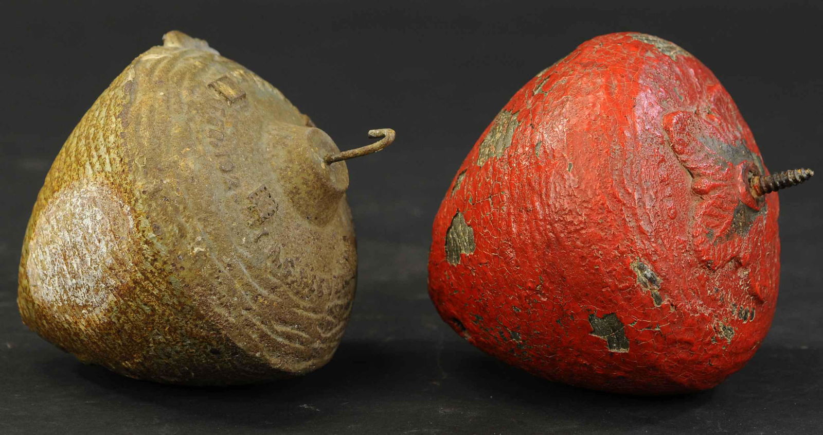 TWO CAST IRON BIRDHOUSES: 194. TWO CAST IRON BIRDHOUSES | Rare unique cast iron birdhouses, clever design, we have never seen another. Silver house marked "Copy 1922". 8" h. | Some chipped paint on red house, silver in (Very G