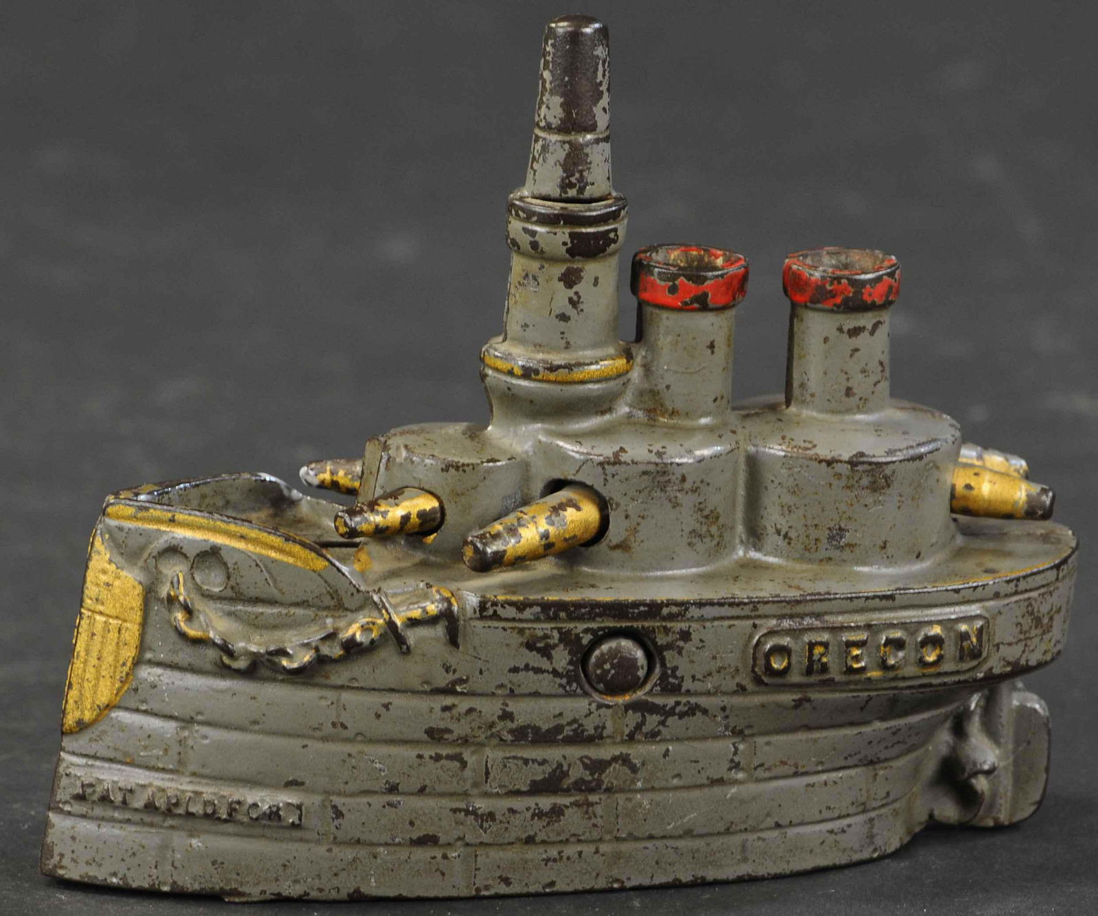 MEDIUM BATTLESHIP OREGON STILL BANK: 306. MEDIUM BATTLESHIP OREGON STILL BANK | 6" l. | (Very Good to Excellent Condition) | $300 - $400